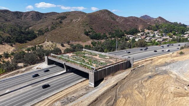 CALIFORNIA - 9.22.2026 - Good aerial view of Highway 101 traffic moving under the Wallis Annenberg Wildlife Crossing, still under construction.
