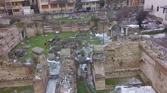 White seagull flying over ancient roman ruins in winter
