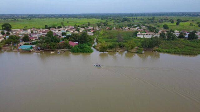 GAMBIA - 12.19.2025 - Wonderful aerial footage tracking a boat on the Gambia River as it approaches Kuntaur.