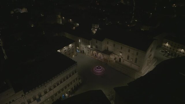 Aerial view of Piazza IV Novembre with the illuminated Fontana Maggiore at night in the historic center of Perugia, Umbria, Italy.