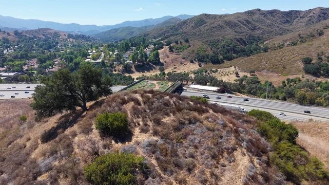 CALIFORNIA - 9.22.2026 - Amazing aerial footage cresting a hill by California's Highway 101 to reveal the Wallis Annenberg Wildlife Crossing, still under construction.