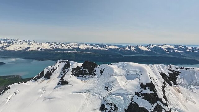 ALASKA - 9.3.2026 - Incredible aerial footage cresting snow-covered mountains to reveal Tebay Lakes in Alaska's Wrangell�St. Elias National Park and Preserve.