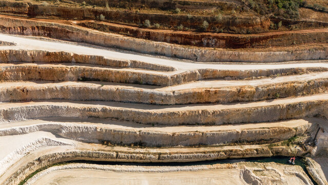 Aerial view of the terraced rock formations and deep quarry pit in Besenovo, Vojvodina, Serbia.