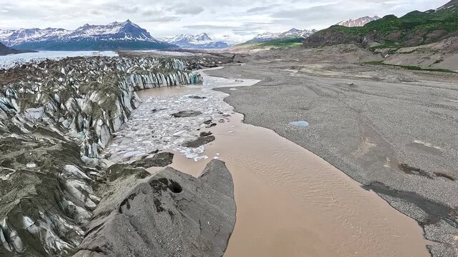 ALASKA - 9.3.2026 - Very good aerial footage flying over glacier outwash and towards snowy mountains in Alaska.