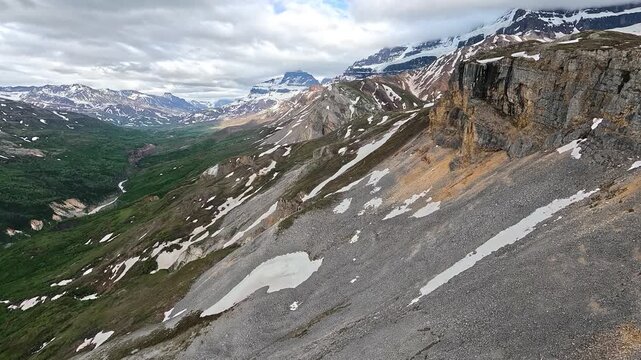 ALASKA - 9.3.2026 - Amazing aerial footage moving past slightly snowy mountains in Alaska.