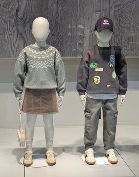 Moda oto&ntilde;o invierno. Escaparate con maniqu&iacute;es con ropa infantil para ni&ntilde;os y ni&ntilde;as de estilo casual con complementos, en tienda de ropa H & M en Madrid, Espa&ntilde;a, 25 de septiembre de 2026	