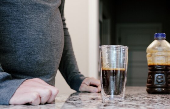 Middle aged man drinking prune juice to aide digestive health naturally - gut health constipation relief remedy aging gracefully preventive wellness