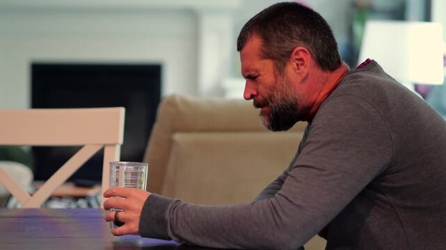 Middle aged man drinking prune juice to aide digestive health naturally - gut health constipation relief remedy aging gracefully preventive wellness