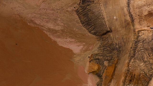 Aerial view of the textured landscape showcasing industrial patterns in the sand and earth with vibrant natural colors Kalbarri, Western Australia, Australia.