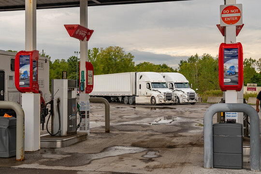 Rochester, NY, US-September 20, 2026: Gas station with several vehicles filling up with diesel fuel and gasoline.