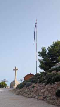 National flag of croatia and stone cross on srd hill