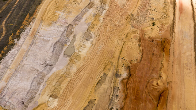 Aerial view of industrial salt mine patterns with textured sand, salt deposits, and earth tones near Useless Loop in Kalbarri, Western Australia, Australia.