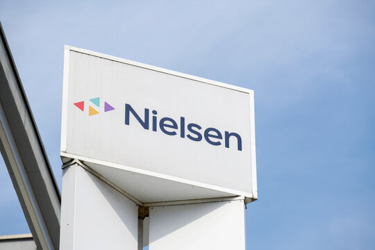Low angle view of the Nielsen company totem sign at office building in Lugano
