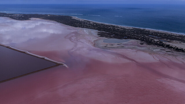 Aerial view of the vibrant pink salt lakes and industrial patterns at Useless Loop near the coastline in Kalbarri, Western Australia, Australia.