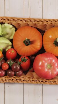 Colorful Garden Vegetables Fill Harvest Basket Flat Lay Stop Motion Vertical Video
