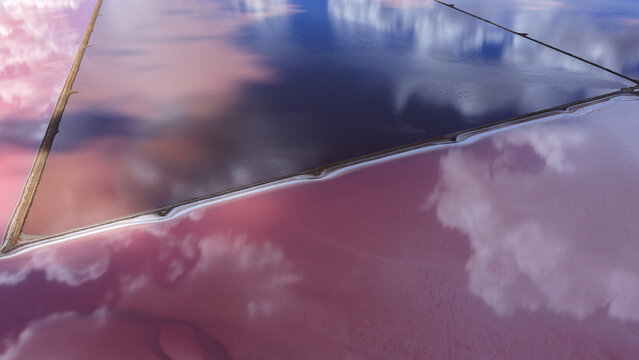 Aerial view of pink salt lake industrial patterns with vibrant colors and cloud reflections in Kalbarri, Western Australia, Australia.