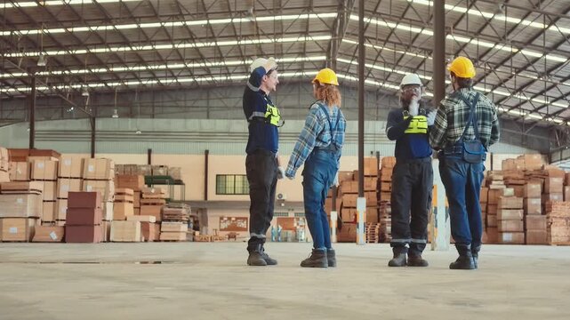 Workers in a warehouse discuss safety measures and equipment during a team meeting at a construction site