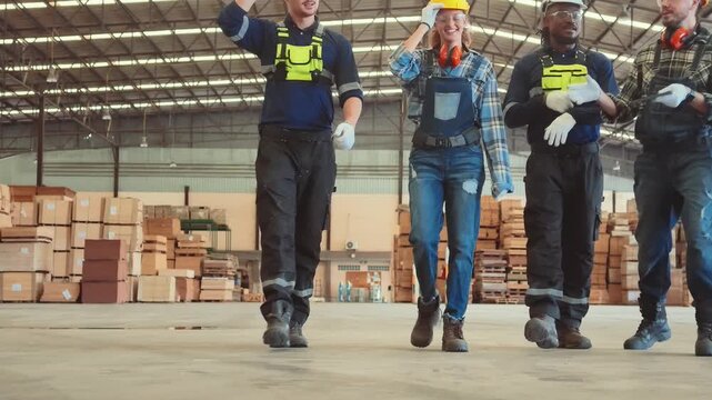 Workers walk through a warehouse while discussing safety procedures and operations