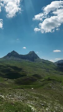 Panoramic view of rugged peaks and green slopes at Sedlo Pass in Durmitor Montenegro. Summer scenery for hiking tourism adventure and outdoor travel
