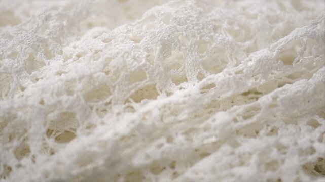 Crochet lace pattern, crocheted wedding dress, detail of hand-crocheted tablecloth background art design. Craft, vintage. Hobby concept background 