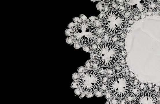 Tenerife lace, needle lace antique traditional doily also known as Spanish Sol Lace embroidery, whitework, white work, needlework. Isolated on black background, border art design, top view, vintage