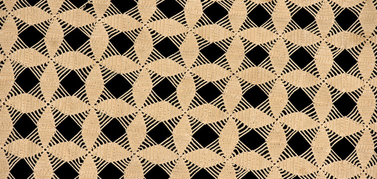 Crochet lace patterns background, crocheted beige Doily geometric motif, detail of hand-crocheted embroidery, tablecloth, napkin isolated on black design. Craft, vintage linen texture. Flat lay