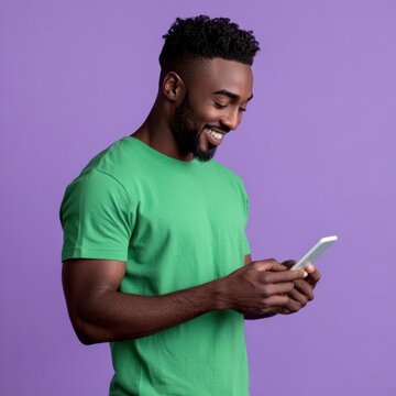 An isolated black man wearing green shirt playing his phone with smile background person modern.