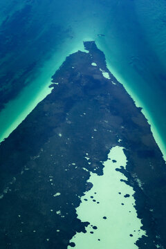 Aerial view of turquoise water and intricate sandbank patterns in the shallow coastal waters of the Shire of Shark Bay, Western Australia, Australia.