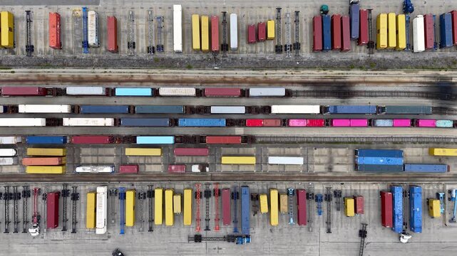 Aerial top down view of freight trains and container terminal