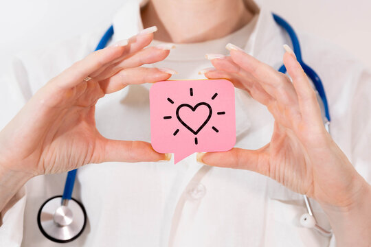 Healthcare Professional Holding Heart Symbol for Care and Health Support Concept.