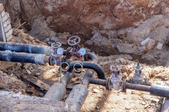 Underground Utility Pipeline with Valves and Pressure Gauges During Repair.