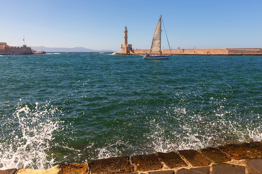 Sailboat and Venetian Lighthouse in Chania Harbor, Crete, Greece