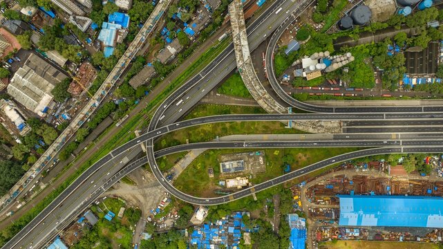Aerial view of the Atal Bihari Vajpayee Sewri-Nhava Sheva Atal Setu interchange featuring multi-level flyovers and surrounding urban infrastructure in Mumbai, Maharashtra, India.