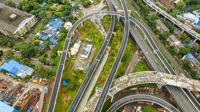 Aerial view of the Atal Bihari Vajpayee Sewri-Nhava Sheva Atal Setu bridge interchange with multi-level flyovers and urban infrastructure in Mumbai, Maharashtra, India.