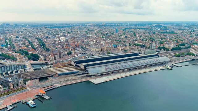 Amsterdam, Netherlands. Amsterdam Central Station. Amsterdam Centraal - The largest train station in the city, built in 1889. Bay IJ (Amsterdam). Drone footage