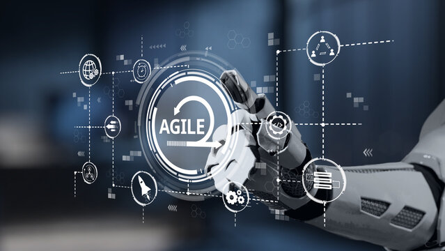 A robotic hand engages with a digital interface showcasing agile concepts, highlighting the intersection of technology and innovation in a modern environment. Salient