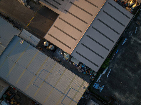 Aerial view of industrial factory buildings with metal roofs and storage tanks in Kilsyth South, Melbourne, VIC, Australia.