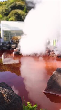 Umi Jigoku, (Sea hell), Kannawa district, Beppu City, Beppu Jigoku, Japan, steaming hot spring pond at Hells of Beppu tour, Oita Prefecture, Kyushu Island, vivid mineral colored geothermal water
