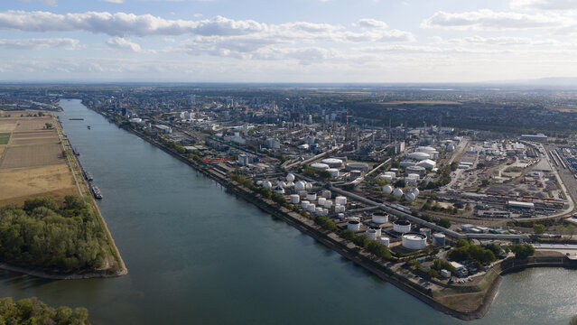 Aerial view of the BASF chemical plant along the Rhine river with industrial infrastructure, storage tanks, and urban surroundings in Ludwigshafen am Rhein, Rheinland-Pfalz, Germany.