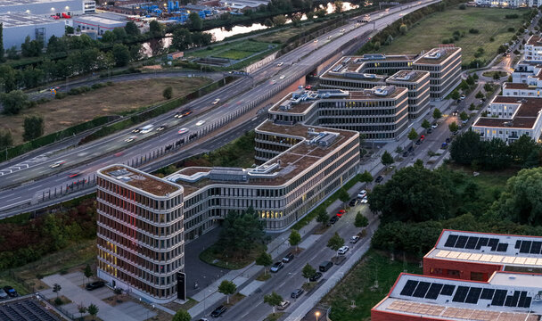 Aerial view of the Brain Box Campus in Adlershof, featuring modern office buildings with green roofs, adjacent to a highway with traffic in Berlin, Berlin, Germany.