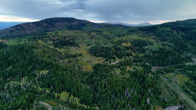 Aerial flyover of the Utah's Uinta mountains to a remote campsite at the beginning of autumn