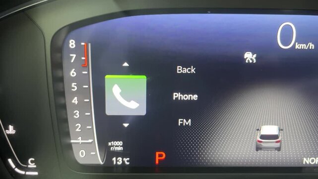 Car digital cockpit screen displaying phone menu and tachometer interface.
