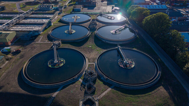 Aerial view of the Water Treatment Centre Camberley featuring large circular settling tanks and industrial infrastructure in Camberley, England, United Kingdom.