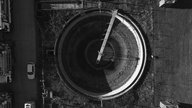 Aerial view of the Water Treatment Centre in Camberley, featuring a large circular sedimentation tank with a central rotating bridge. Camberley, England, United Kingdom.