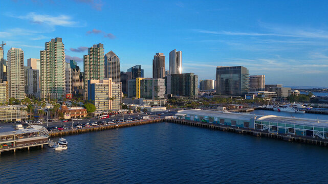 Aerial view of the San Diego skyline and waterfront along North Harbor Drive and North Embarcadero with modern skyscrapers and harbor piers in San Diego, California, United States.