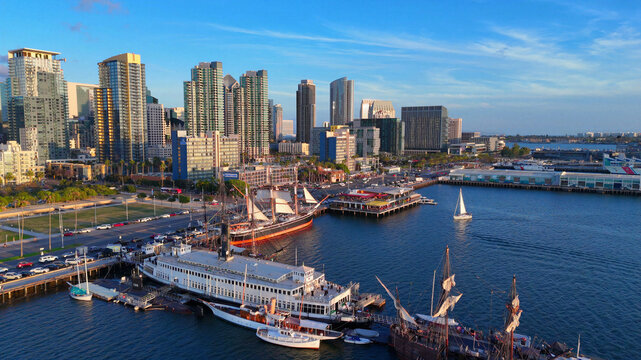 Aerial view of the San Diego waterfront, featuring the North Embarcadero, historic tall ships, the Berkeley ferryboat, and the city skyline in San Diego, California, United States.