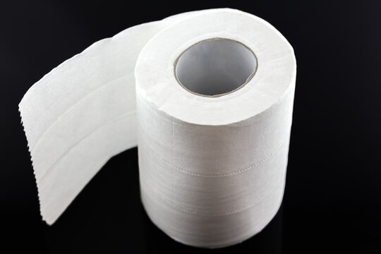 A single unrolled roll of white toilet paper, displayed against a solid black background, showing its cylindrical shape and unrolled sheet.