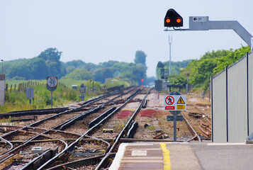 Technical view of railway junction tracks with signals and safety signs. © LocalDreamer