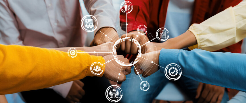 Startup company employee team stacking hand together symbolize successful group of business partnership and strong collective unity teamwork in community workplace in panoramic banner. Synergic Amity