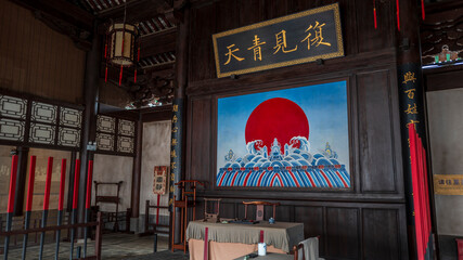Interior of ancient Linan Prefecture yamen in Jianshui, Yunnan, China, ancient Chinese government courtroom with plaque and mural © Deng Xuejun
